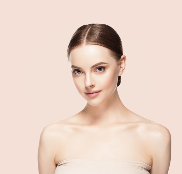 Woman face beauty healthy skin natural makeup beautiful female beige background